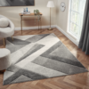 Orbit Lumen Grey rug featuring soft grey gradients and a smooth modern texture, laid out in a bright contemporary room.