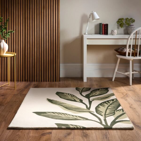 Origins Paradise Leaf rug with layered green leaf detailing and a hand‑carved wool texture on a soft cream base.