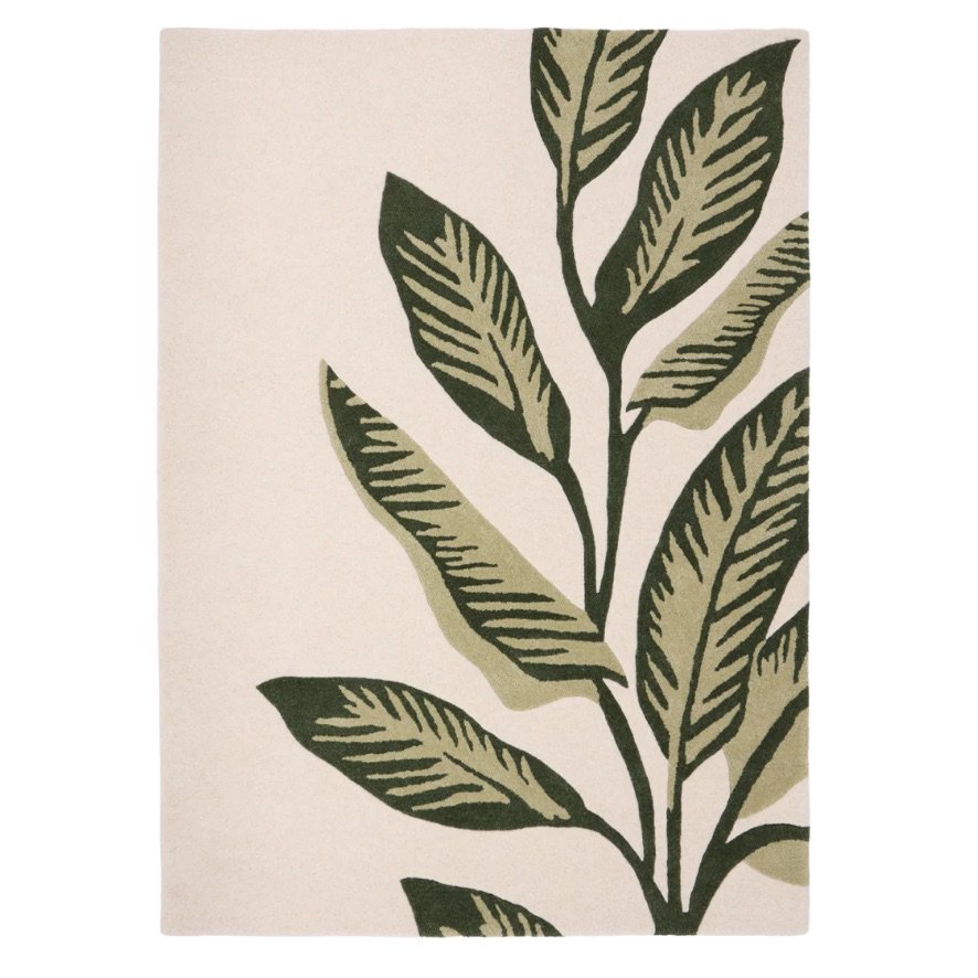 Origins Paradise Leaf rug with oversized green leaf motif and hand‑carved wool texture on an ivory background.