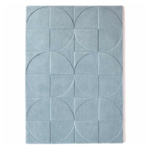 Origins Penny Steel Blue rug in a deep blue tone with a circular carved wool pattern.