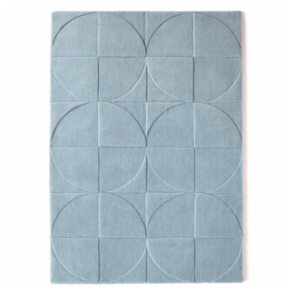 Origins Penny Steel Blue rug in a deep blue tone with a circular carved wool pattern.