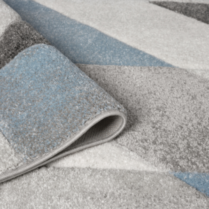 Orbit Alto rug with cool blue gradients and a subtle textured finish, styled on a clean modern floor.