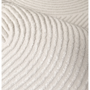 Light ivory rug with raised curved detailing and subtle layered tones