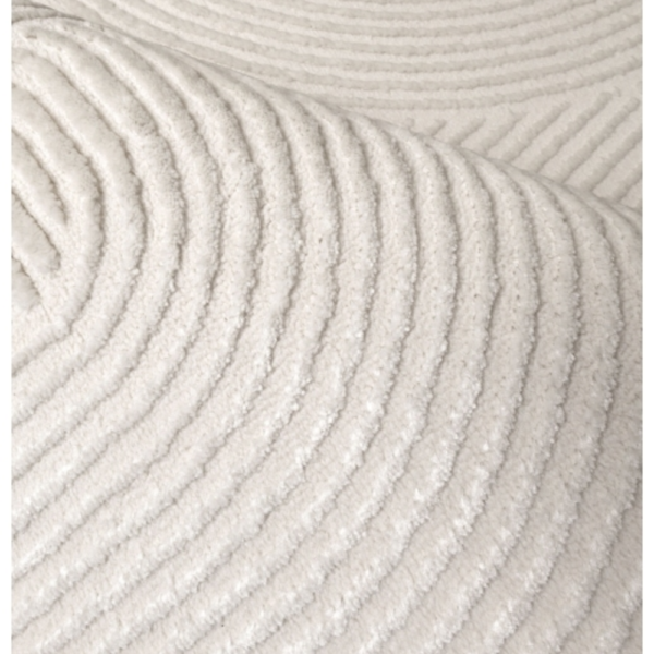 Light ivory rug with raised curved detailing and subtle layered tones