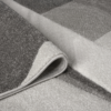 Orbit Lumen Grey rug with subtle tonal shading and a clean textured finish, styled on a minimalist floor surface.