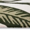 Origins Paradise Leaf rug featuring a sculpted oversized leaf design in rich green tones on a wool pile.