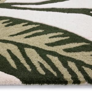 Origins Paradise Leaf rug featuring a sculpted oversized leaf design in rich green tones on a wool pile.