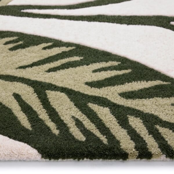 Origins Paradise Leaf rug featuring a sculpted oversized leaf design in rich green tones on a wool pile.