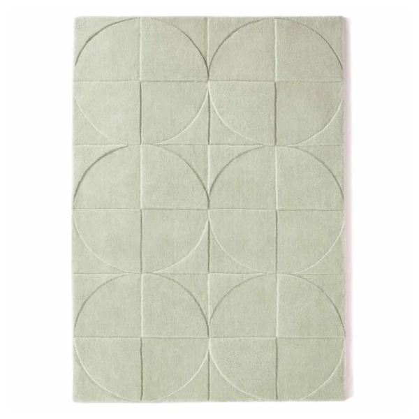 Origins Penny Eucalyptus rug with a muted green tone and carved circular wool texture.