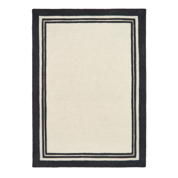 Piper Monochrome rug featuring a bold black border around a soft cream wool centre.