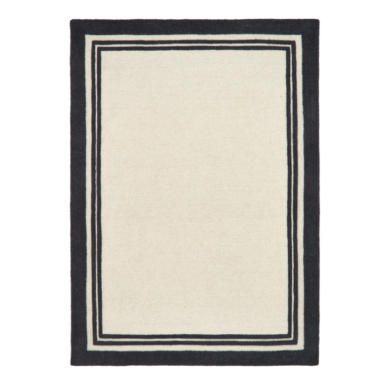 Piper Monochrome rug featuring a bold black border around a soft cream wool centre.