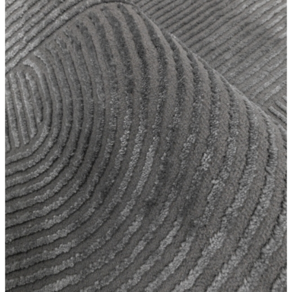 Textured charcoal rug showing soft curved arches and a bold sculpted finish
